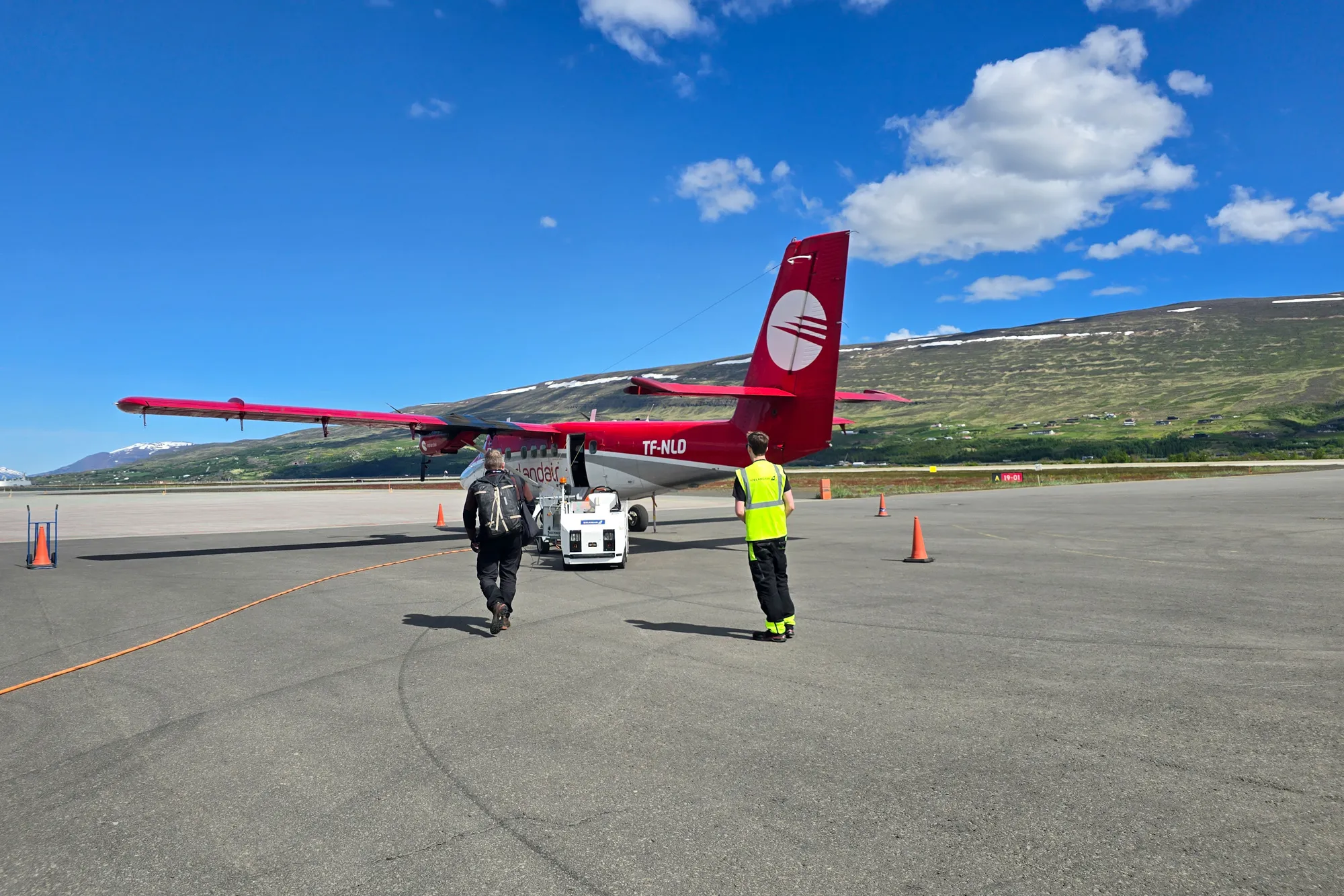 small plane and person walking towards it for boarding