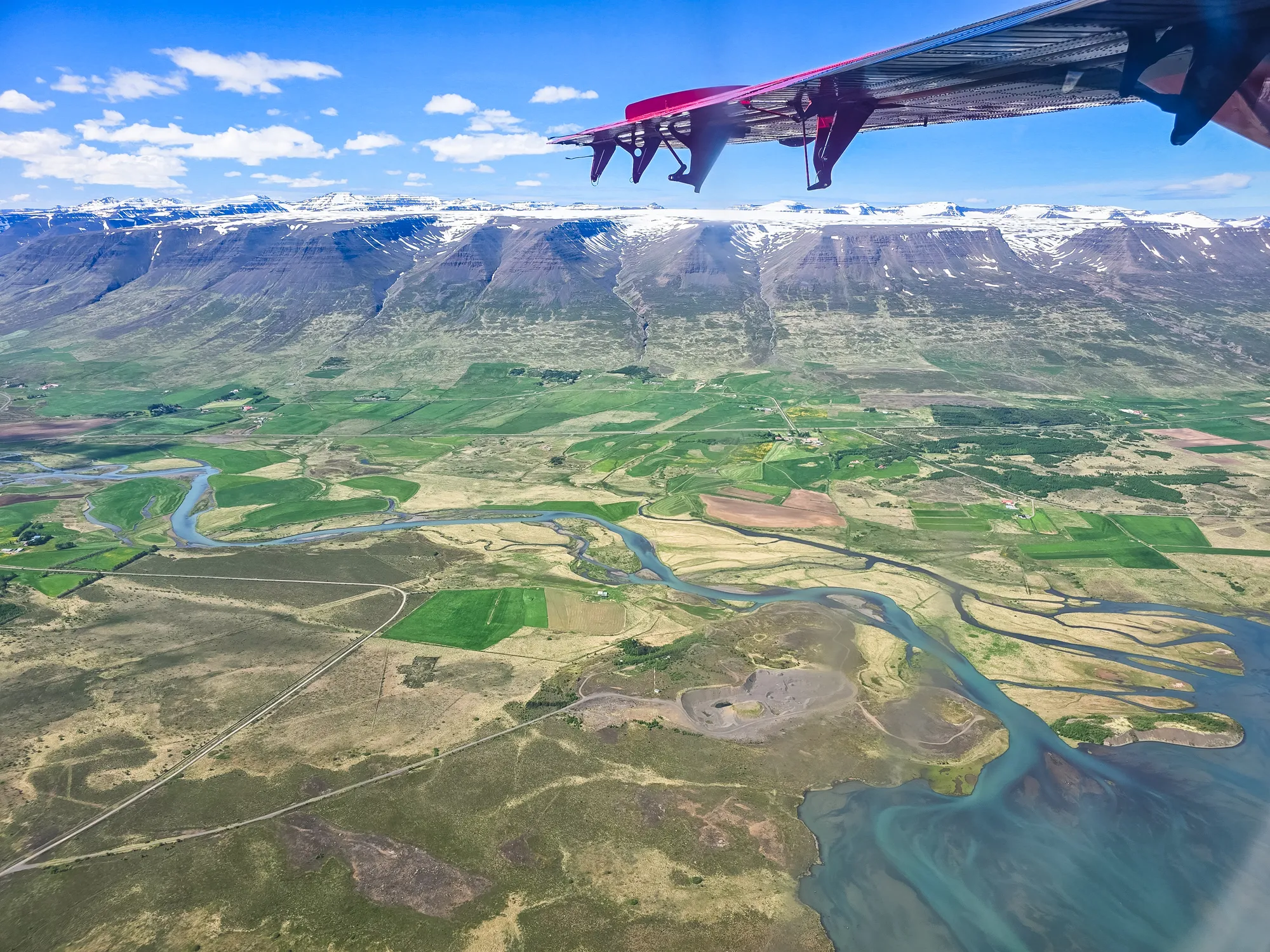 view of mountain range and fjord flowing into the ocean