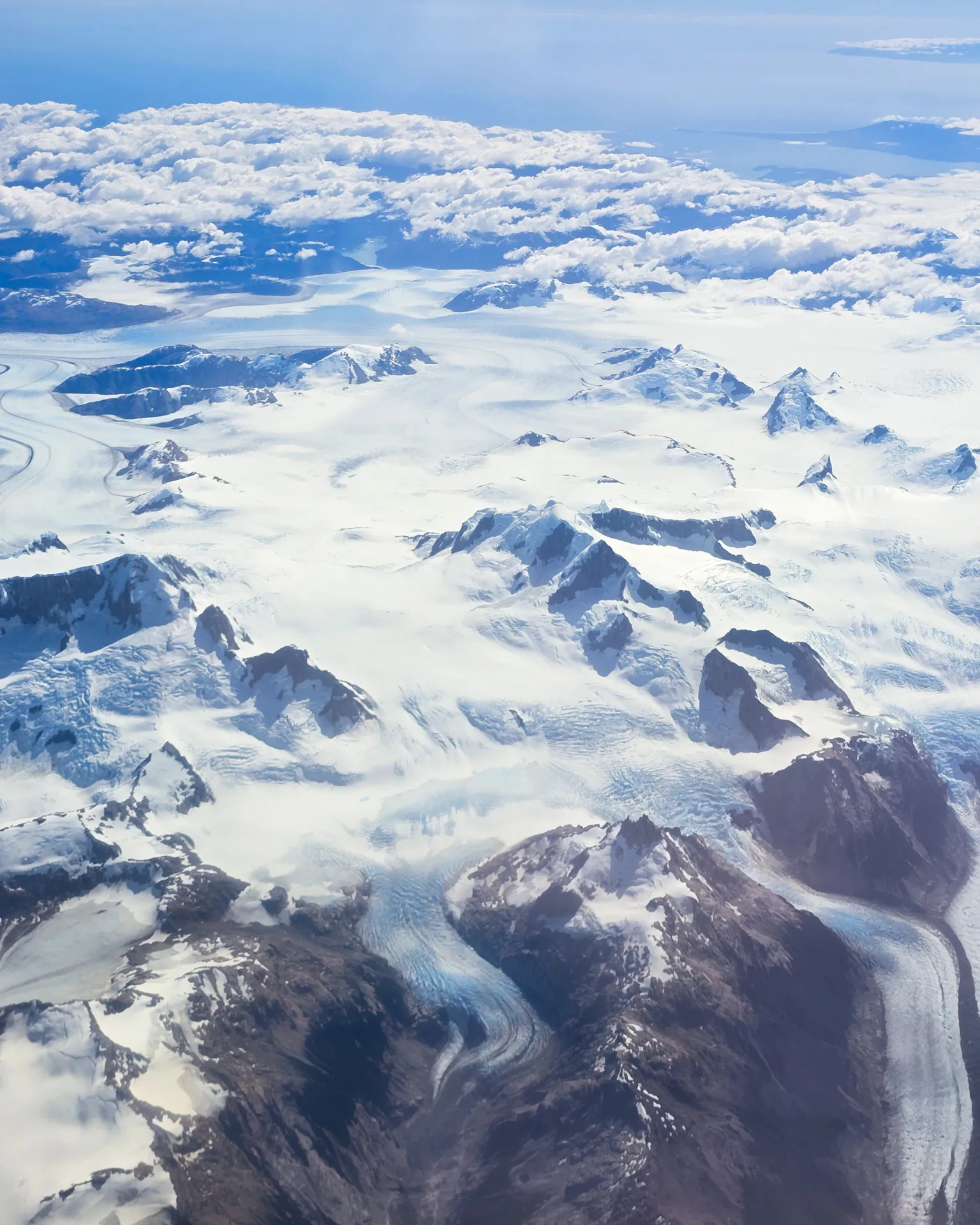 Andes Airplane Shot 1: showing mountains and glaciers and clouds in the back