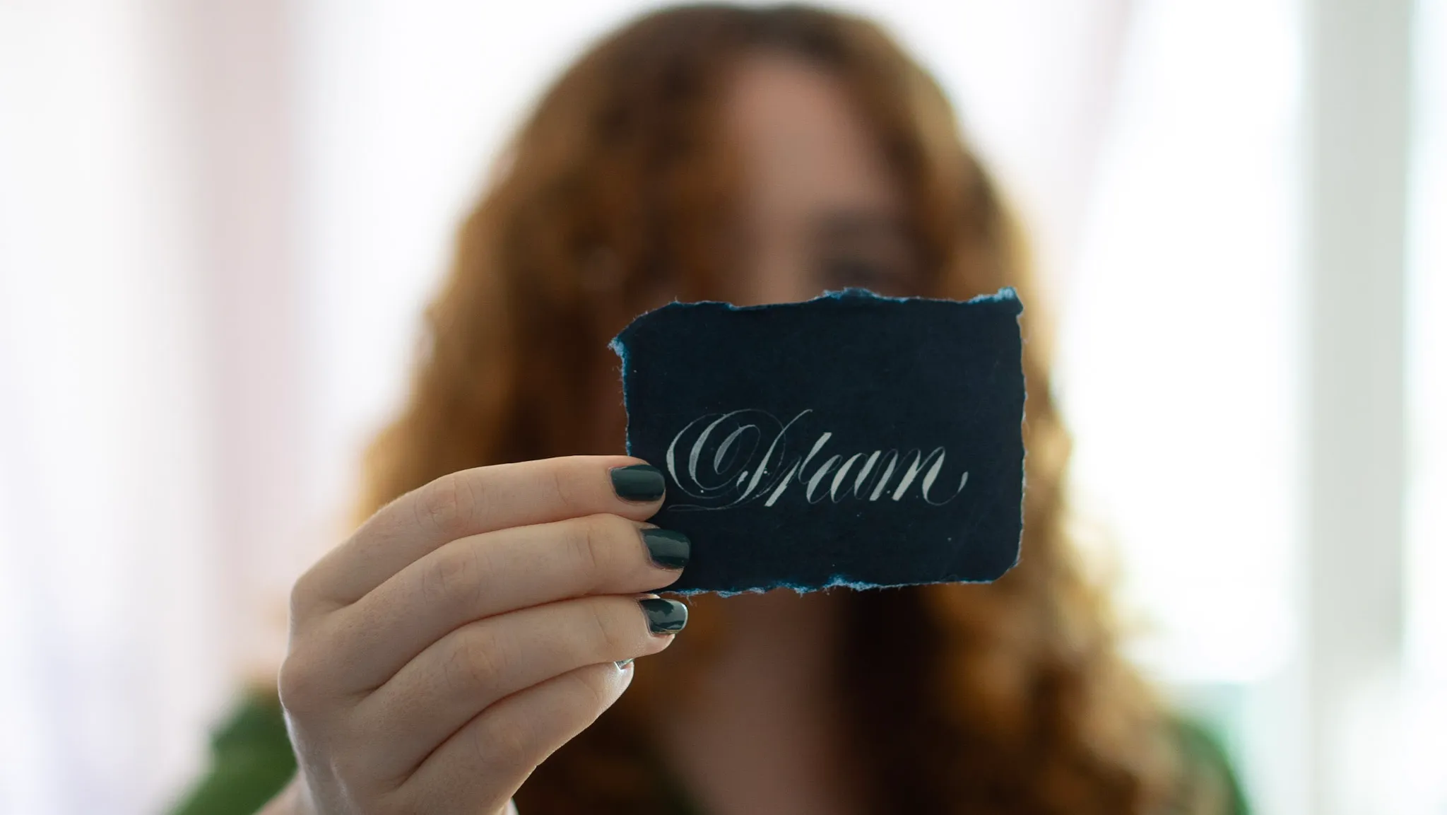 Myriam holding up a lettered piece saying 'dream'
