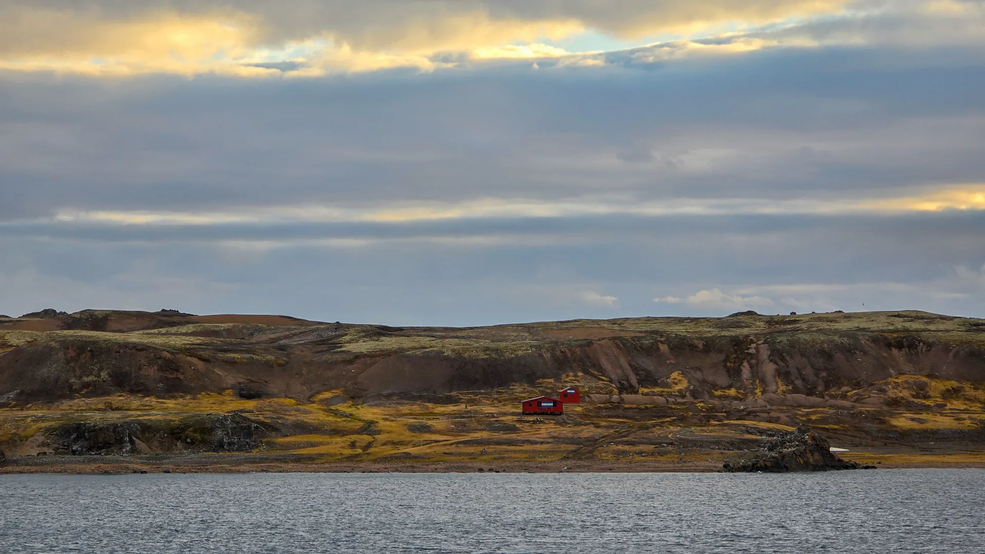 first landscape shot, no snow, just rolling hills and a few red huts