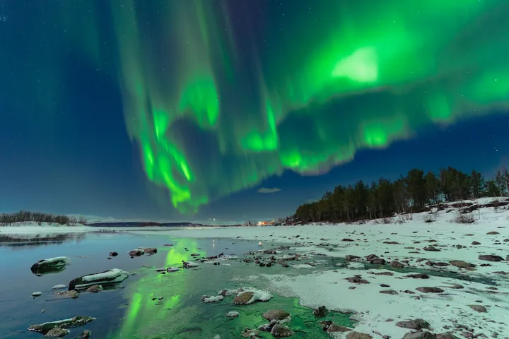 a photo of the northern lights with calligraphy lettering saying "Chasing Dances in the Sky"