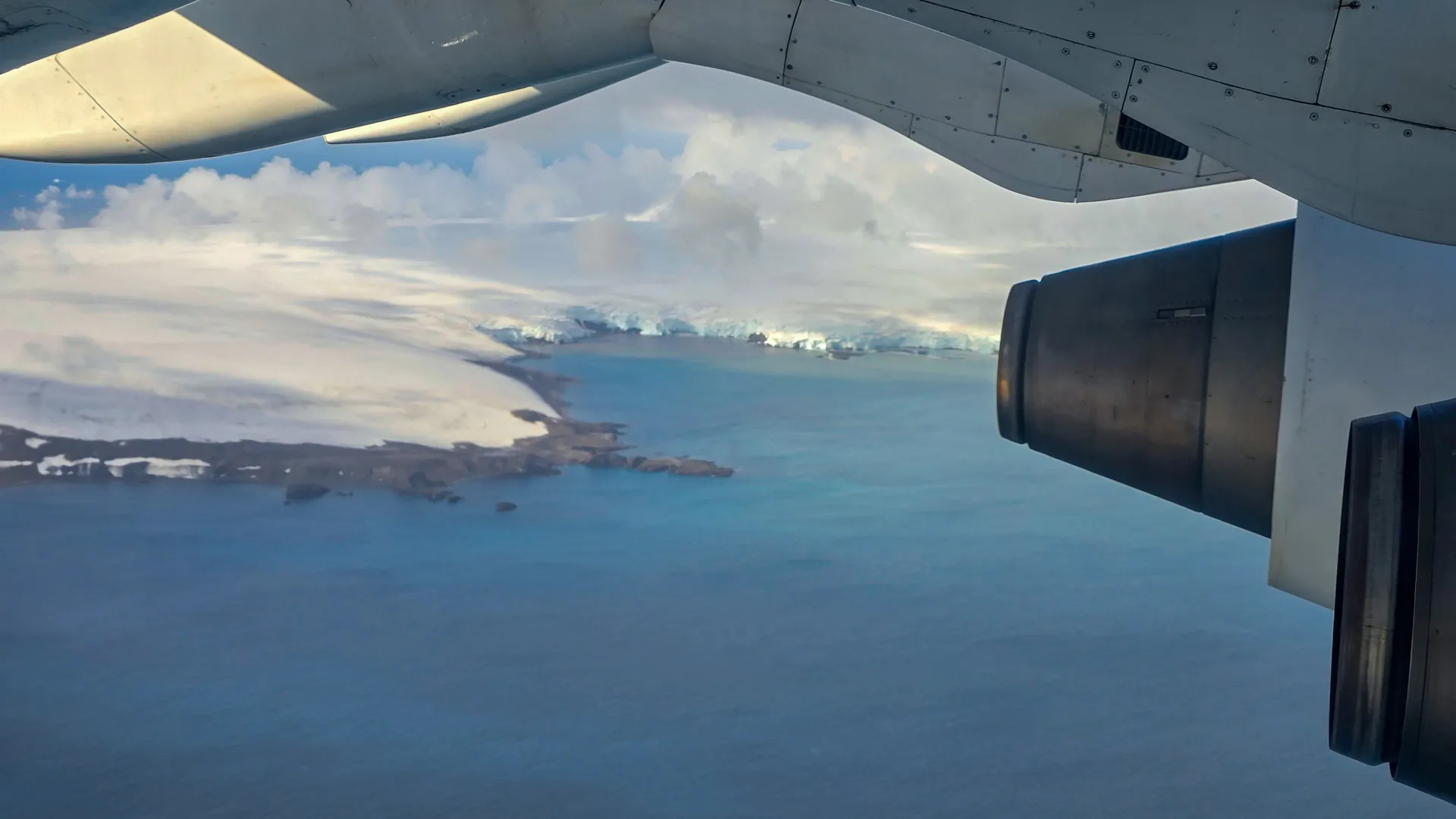 first glimpse of the continent under plane wing