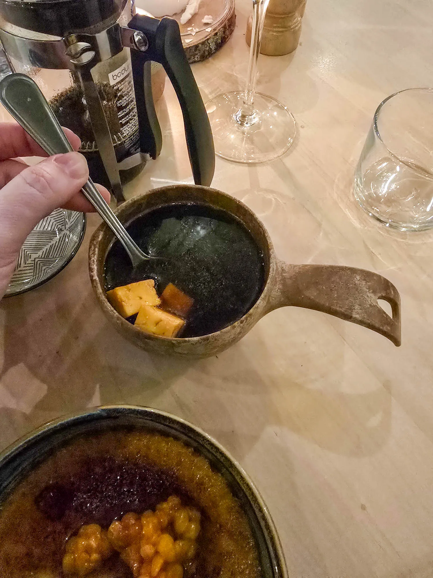 stirring bread cheese in guksi