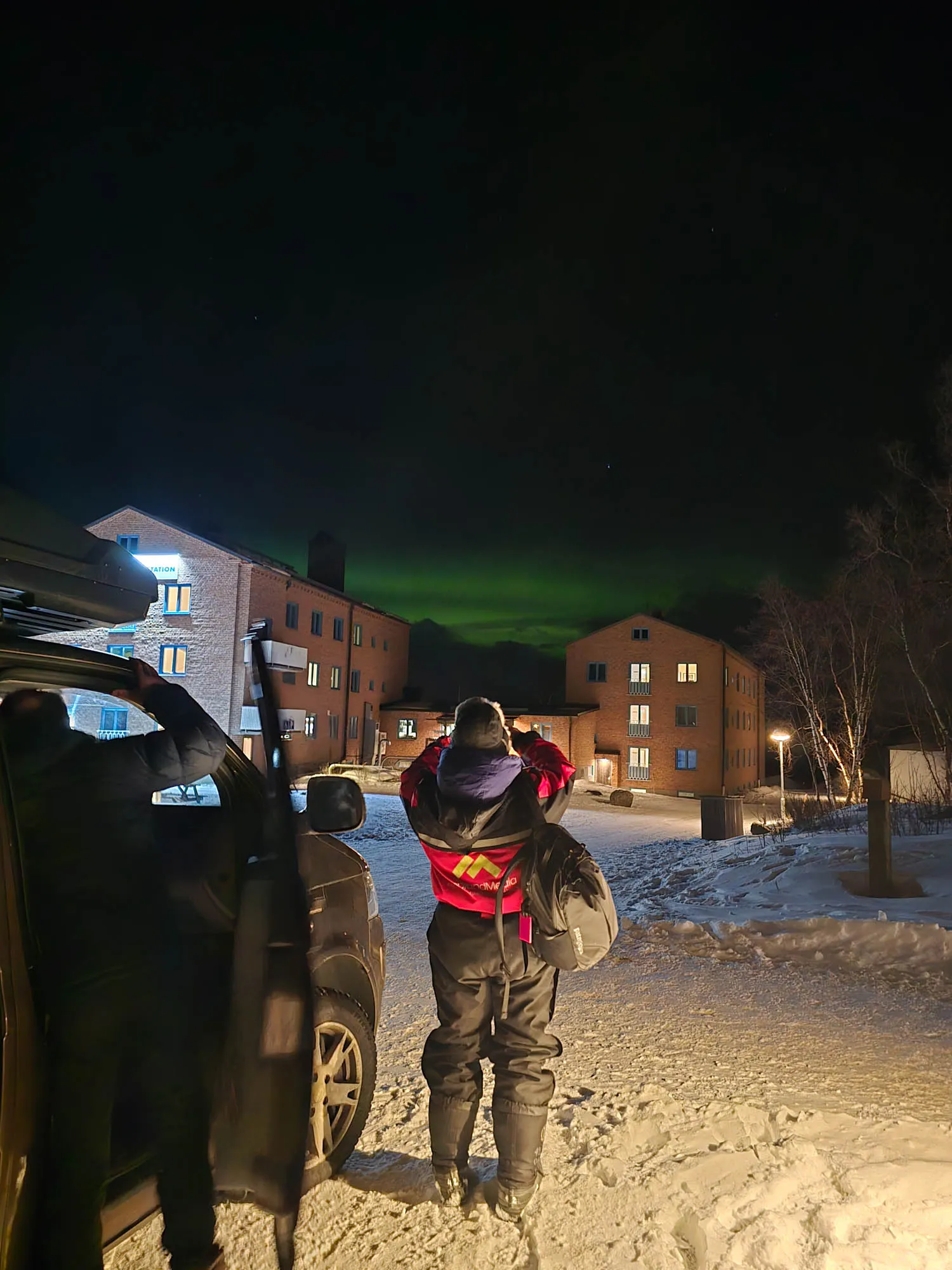 glimpses of aurora behind hotel